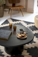 Detail of small black coffee table in modern living room