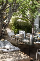 Outdoor dining area in shade of tree in summer