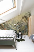 Jungle themed feature wall in childrens attic bedroom