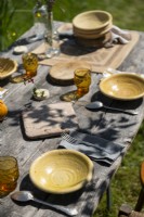 Detail of country garden dining table in summer laid for lunch