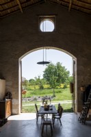 Rustic dining room with view to garden and countryside beyond