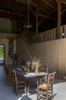 Rustic dining table in converted country barn home