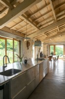 Contemporary open plan kitchen and dining area in converted barn