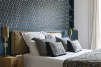 Detail of feature wall and bed in classic style bedroom