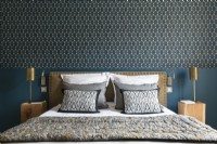 Patterned wallpaper above bed in classic style bedroom