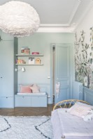 Blue painted wall with built-in bench seat and storage
