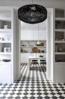 View through doorway to contemporary monochrome kitchen-diner