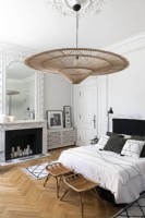 Large wicker lampshade and period details in classic style bedroom 
