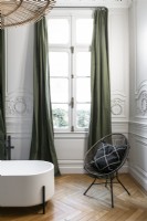 Modern seating in classic bathroom with period details