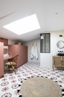 Modern bathroom with flower patterned pink floor tiles 