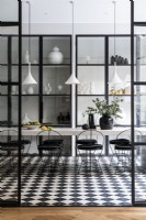 Contemporary monochrome dining room with crittall doors