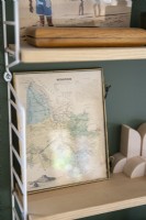 Detail of framed map on shelf