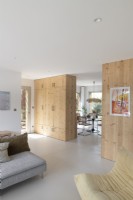 Wooden room dividers with built-in storage in open plan living space