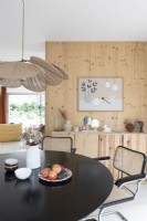 Wood cladding on wall and built-in sideboard in modern dining room
