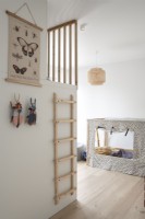 Wall mounted ladder to bunk bed in childrens room