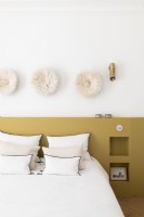 Alcove shelves in built-in headboard wall in modern bedroom