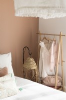 Simple wooden clothes rail in modern bedroom