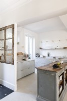 Distressed wooden window frame and island in modern kitchen