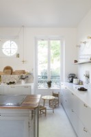 Tiny wooden childrens table and chairs in modern kitchen