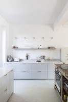 Modern white kitchen with pale grey cabinets