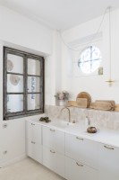 Modern white kitchen with distressed wooden window frame