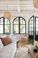 Modern living room with large arched windows and French doors