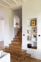 Wooden staircase and white painted walls
