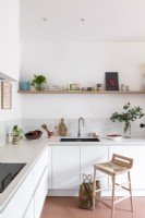 Wooden barstool in modern white kitchen