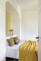 Modern bedroom with arched alcove around head of bed
