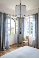 Pale blue curtains in white bedroom
