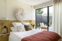 Modern bedroom with open patio doors to terrace