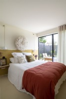 Modern bedroom with patio doors to terrace garden