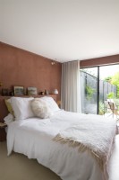 Brown fabric wall in modern bedroom with patio doors