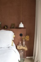Brown painted modern bedroom with white bedding