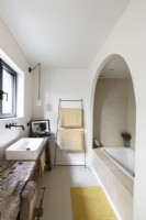 Bath in arched alcove in modern bathroom 