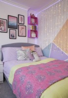 Bedroom with colour blocking, fairy lights and a gallery wall.