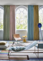 Contemporary living room with curtains on arched windows