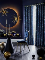 Contemporary Christmas table setting with wall art and curtains