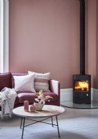 Pink living room with wood burning stove