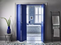 En suite bathroom with blue shutter dividing doors