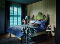 Traditional bedroom with turquoise shutters