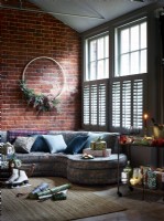 Christmas living room with large wreath and shutters