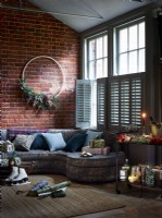 Living room with large wreath and shutters cracked open