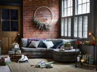 Christmas living room with large wreath, gifts and shutters
