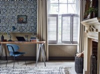 Home office with fireplace, shutters and curtains
