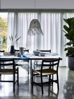 Dining room with voile diffuser curtains