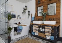 Bathroom with wooden panelling behind double sinks, white metro tiles and a walk in shower.