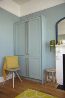 Detail of blue in-built cupboards in an open plan kitchen-diner.
