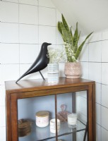 Bathroom detail showing mid-century cabinet for storage and white tiling.
