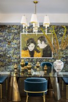 Ornate dining room with floral patterned wallpaper and painting of Steve McQueen and Jacqueline Bisset.